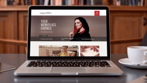 The Scottish Widows website on a laptop next to a cup of coffee